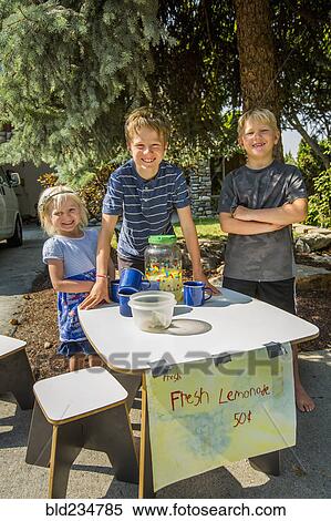 Smiling Caucasian boys and girl selling lemonade View Large Photo Image Stock Photography - Smiling Caucasian boys and girl selling lemonade. Fotosearch