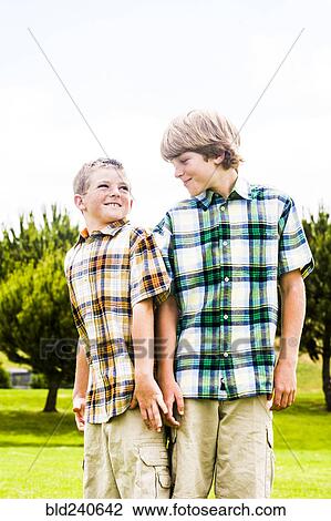 Smiling Caucasian brothers wearing plaid shirts View Large Photo Image Stock Image - Smiling Caucasian brothers wearing plaid shirts. Fotosearch