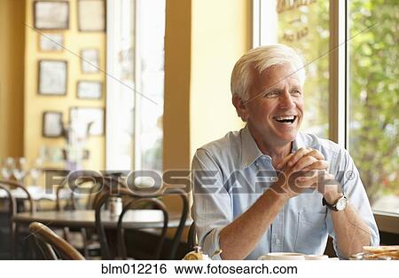 Smiling Caucasian man having lunch in restaurant View Large Photo Image Stock Photograph - Smiling Caucasian man having lunch in restaurant. Fotosearch