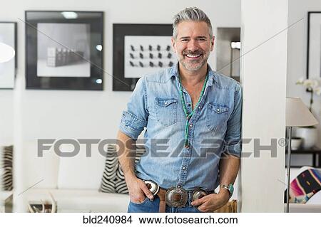 Smiling Caucasian man leaning on pillar View Large Photo Image Picture - Smiling Caucasian man leaning on pillar. Fotosearch