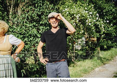 Smiling Caucasian man tipping cap View Large Photo Image Stock Photo - Smiling Caucasian man tipping cap. Fotosearch