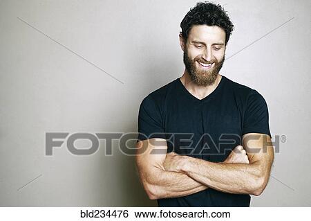 Smiling Caucasian man with beard looking down View Large Photo Image Stock Photograph - Smiling Caucasian man with beard looking down. Fotosearch