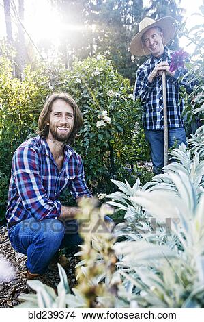 Picture - Smiling Caucasian men posing in garden. Fotosearch
