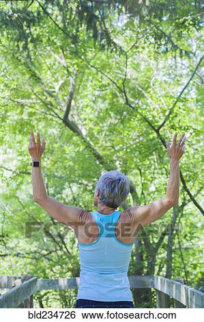 Smiling Caucasian woman celebrating outdoors View Large Photo Image Stock Photograph - Smiling Caucasian woman celebrating outdoors. Fotosearch