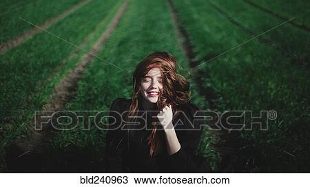 Smiling Caucasian woman in rows of grass View Large Photo Image Stock Image - Smiling Caucasian woman in rows of grass. Fotosearch