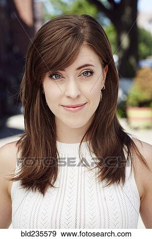 Stock Photo - Smiling Caucasian woman posing in city. Fotosearch