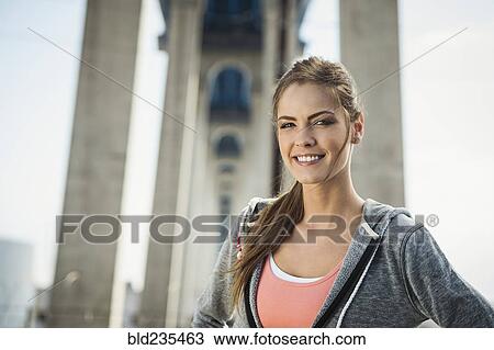 Smiling Caucasian woman posing under overpass View Large Photo Image Stock Image - Smiling Caucasian woman posing under overpass. Fotosearch