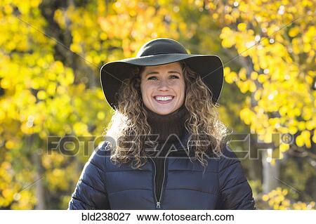 Smiling Caucasian woman under autumn leaves View Large Photo Image Stock Photo - Smiling Caucasian woman under autumn leaves. Fotosearch