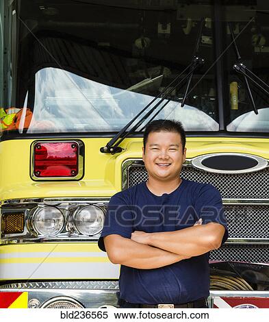 Smiling Chinese fireman posing with fire truck View Large Photo Image Stock Photography - Smiling Chinese fireman posing with fire truck. Fotosearch