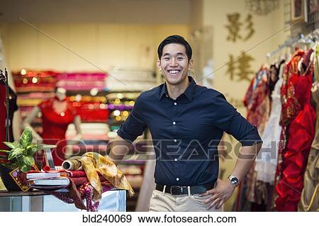 Stock Photo - Smiling Chinese man posing in store. Fotosearch
