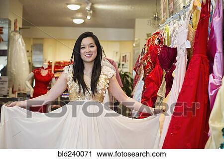 Smiling Chinese woman shopping for dress View Large Photo Image Stock Image - Smiling Chinese woman shopping for dress. Fotosearch