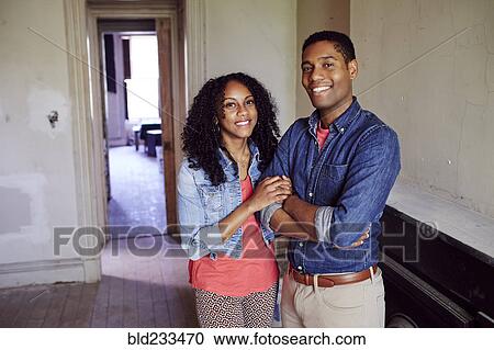 Smiling couple posing in empty house View Large Photo Image Stock Image - Smiling couple posing in empty house. Fotosearch
