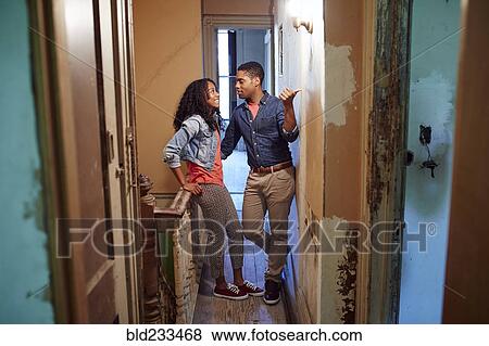Smiling couple talking in corridor of house under renovation View Large Photo Image Stock Photo - Smiling couple talking in corridor of house under renovation. Fotosearch