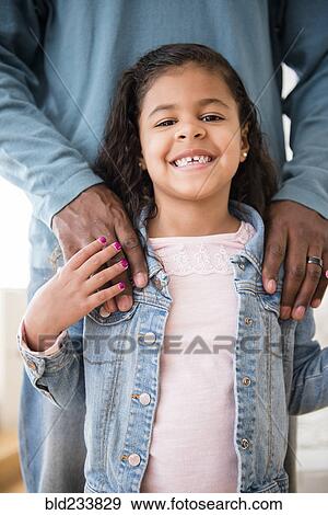 Stock Photo - Smiling daughter posing with father. Fotosearch
