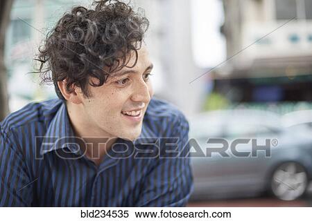 Smiling Hispanic man with curly hair View Large Photo Image Stock Photography - Smiling Hispanic man with curly hair. Fotosearch