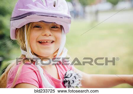 Stock Photography - Smiling Mixed Race girl wearing helmet. Fotosearch