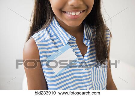 Smiling Mixed Race girl wearing name badge View Large Photo Image Stock Image - Smiling Mixed Race girl wearing name badge. Fotosearch