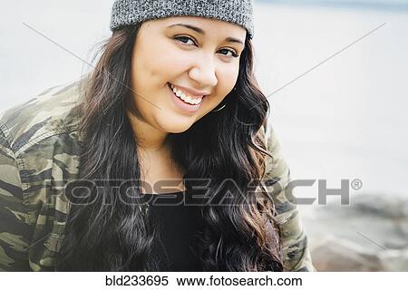 Stock Photography - Smiling Mixed Race woman at ocean. Fotosearch