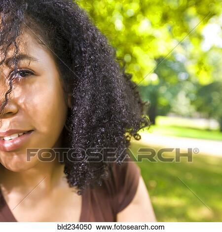 Smiling Mixed Race woman in park View Large Photo Image Stock Image - Smiling Mixed Race woman in park. Fotosearch