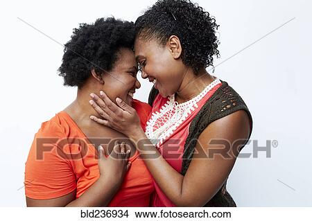 Smiling mother and daughter hugging View Large Photo Image Picture - Smiling mother and daughter hugging. Fotosearch