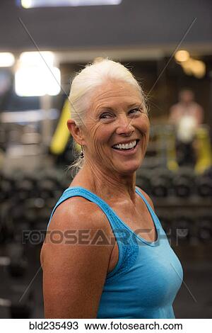 Smiling older woman working out in gymnasium View Large Photo Image Stock Image - Smiling older woman working out in gymnasium. Fotosearch