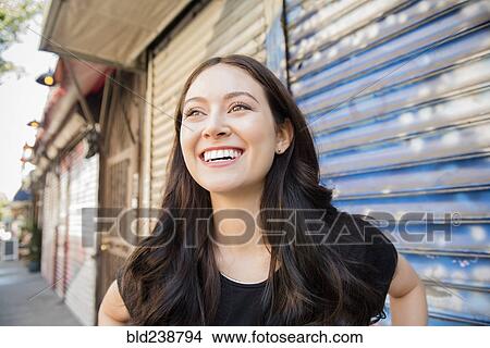 Smiling Thai woman standing on city sidewalk View Large Photo Image Picture - Smiling Thai woman standing on city sidewalk. Fotosearch