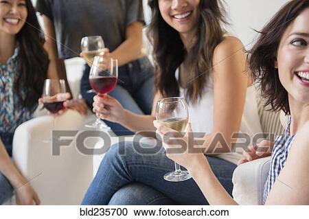 Smiling women drinking wine at party View Large Photo Image Stock Image - Smiling women drinking wine at party. Fotosearch