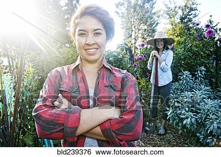 Smiling women posing in garden View Large Photo Image Stock Photograph - Smiling women posing in garden. Fotosearch