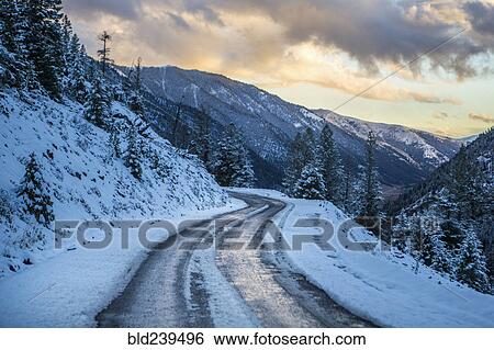 Stock Photograph - Snow on winding mountain road. Fotosearch