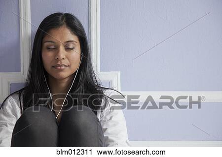 Sri Lankan woman listening to mp3 player View Large Photo Image Stock Image - Sri Lankan woman listening to mp3 player. Fotosearch