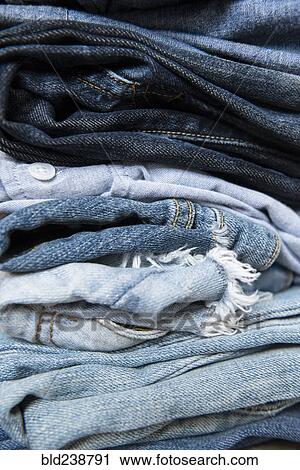 Stock Image - Stack of folded blue jeans. Fotosearch
