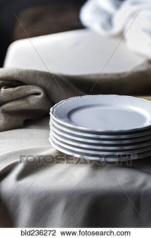 Stack of plates on tablecloth View Large Photo Image Stock Image - Stack of plates on tablecloth. Fotosearch