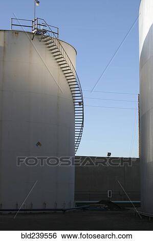 Staircase curving around storage tank View Large Photo Image Stock Photograph - Staircase curving around storage tank. Fotosearch