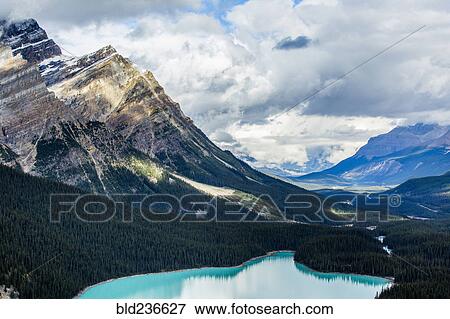 Stock Photo - Still lake in mountain valley. Fotosearch