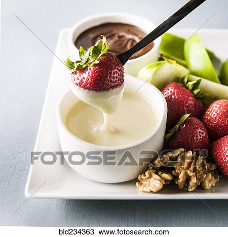 Strawberry dipping in white sauce View Large Photo Image Stock Image - Strawberry dipping in white sauce. Fotosearch