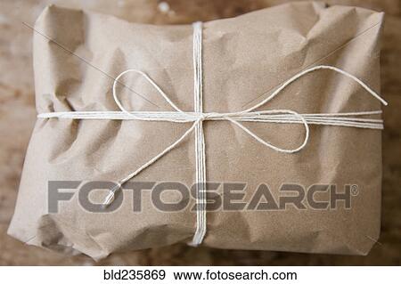 Stock Photo - String tied around package wrapped in brown paper. Fotosearch