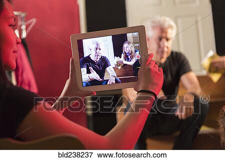 Stock Photo - Student recording teacher in theater class with digital tablet. Fotosearch