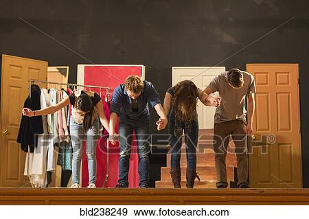 Stock Photo - Students holding hands on stage and bowing. Fotosearch