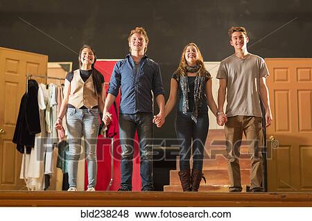 Stock Photo - Students holding hands on stage. Fotosearch