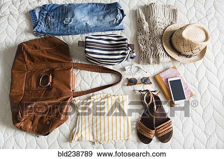 Summer travel clothing of woman on blanket View Large Photo Image Stock Photo - Summer travel clothing of woman on blanket. Fotosearch