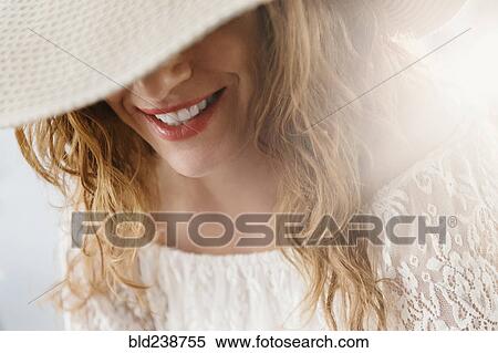 Sun hat covering face of Caucasian woman View Large Photo Image Stock Photography - Sun hat covering face of Caucasian woman. Fotosearch