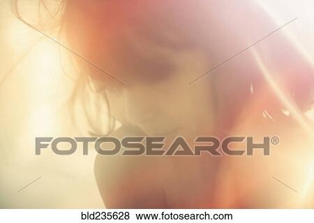 Stock Photo - Sunbeams on Mixed Race girl. Fotosearch
