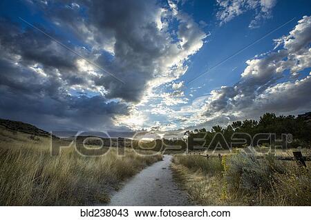 Stock Image - Sunset over distant path. Fotosearch