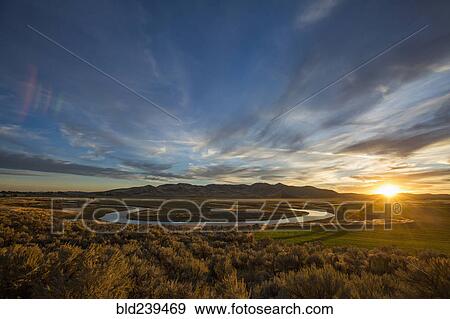 Stock Photo - Sunset over winding river. Fotosearch