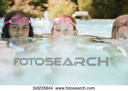Surface level view of faces of girls in swimming pool View Large Photo Image Picture - Surface level view of faces of girls in swimming pool. Fotosearch