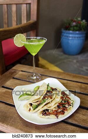 Stock Image - Tacos on plate with margarita. Fotosearch