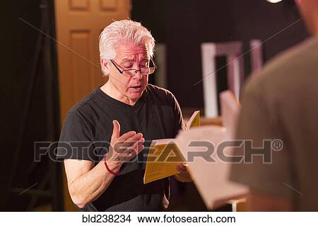 Teacher talking to students in theater class View Large Photo Image Picture - Teacher talking to students in theater class. Fotosearch