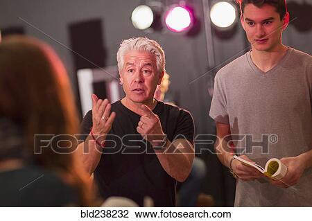 Teacher talking to students in theater class View Large Photo Image Stock Image - Teacher talking to students in theater class. Fotosearch