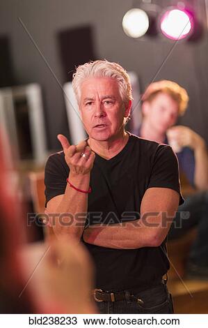 Teacher talking to students in theater class View Large Photo Image Stock Image - Teacher talking to students in theater class. Fotosearch