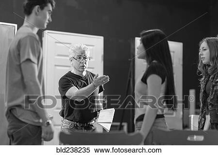 Teacher talking to students in theater class View Large Photo Image Stock Photography - Teacher talking to students in theater class. Fotosearch